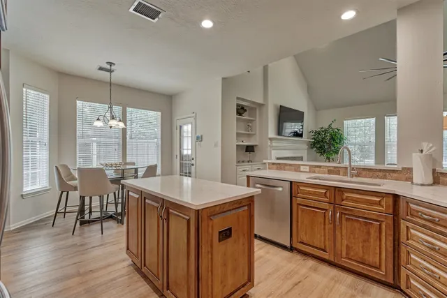 a kitchen with sink cabinets and wooden floor