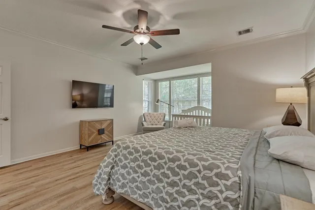 a bedroom with a large bed and a tv