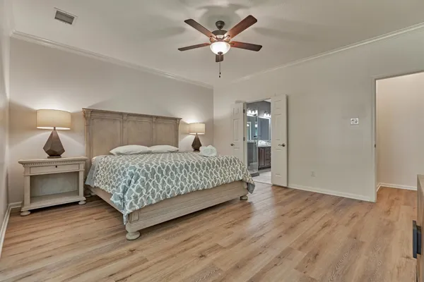 a bedroom with a bed and a chandelier
