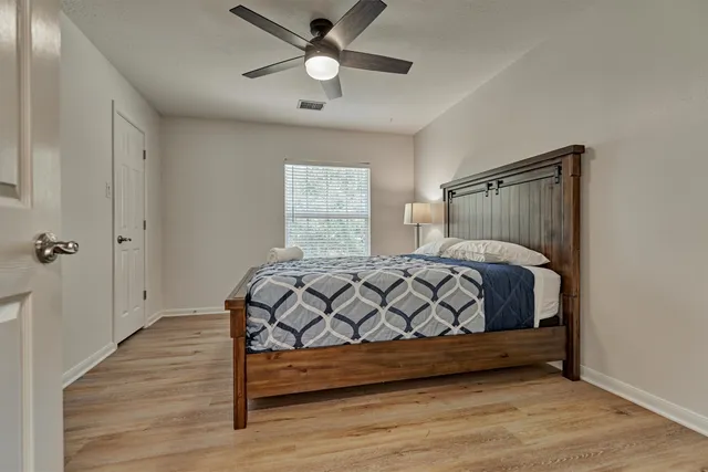 a bathroom with a granite countertop sink toilet and mirror