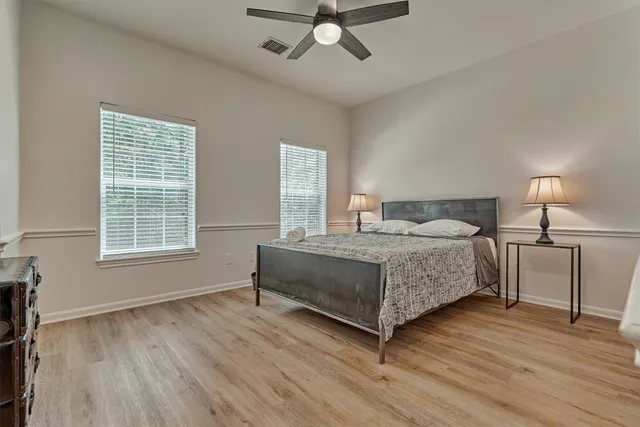 a bedroom with a bed and wooden floor