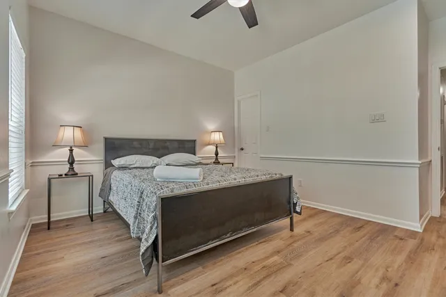 a view of staircase with wooden floor and fan