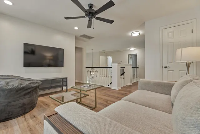 a bed sitting in a spacious bedroom next to a window