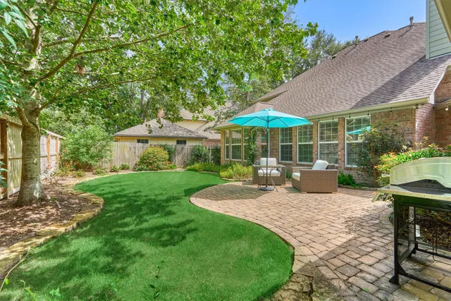 a view of a house with backyard sitting area and garden