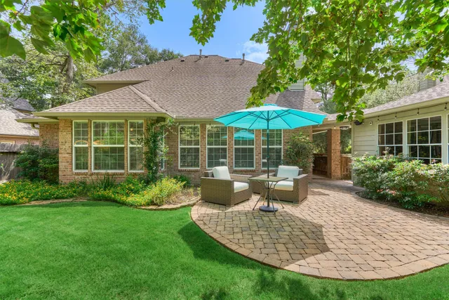 a view of a house with backyard sitting area and garden