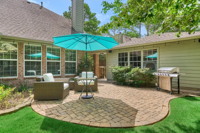 a view of a balcony with wooden floor and iron gate