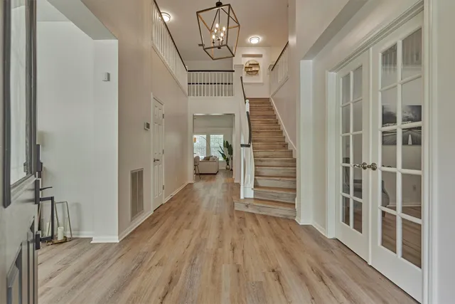 a view of a hallway with wooden floor and staircase