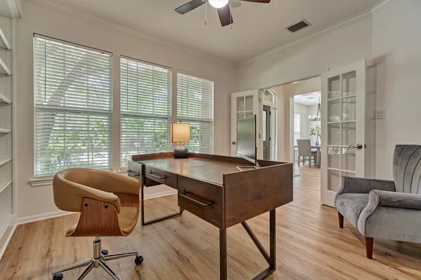 a living room with furniture and a floor to ceiling window