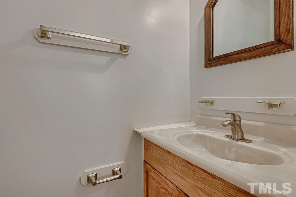 5604 Thea Lane, Unit B Raleigh, NC 27606 - Photo 17 of 27 a bathroom with a sink and a mirror