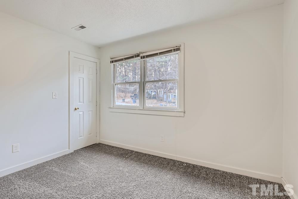 5604 Thea Lane, Unit B Raleigh, NC 27606 - Photo 20 of 27 a view of an empty room with a window