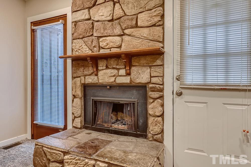 5604 Thea Lane, Unit B Raleigh, NC 27606 - Photo 23 of 27 a living room with a fireplace