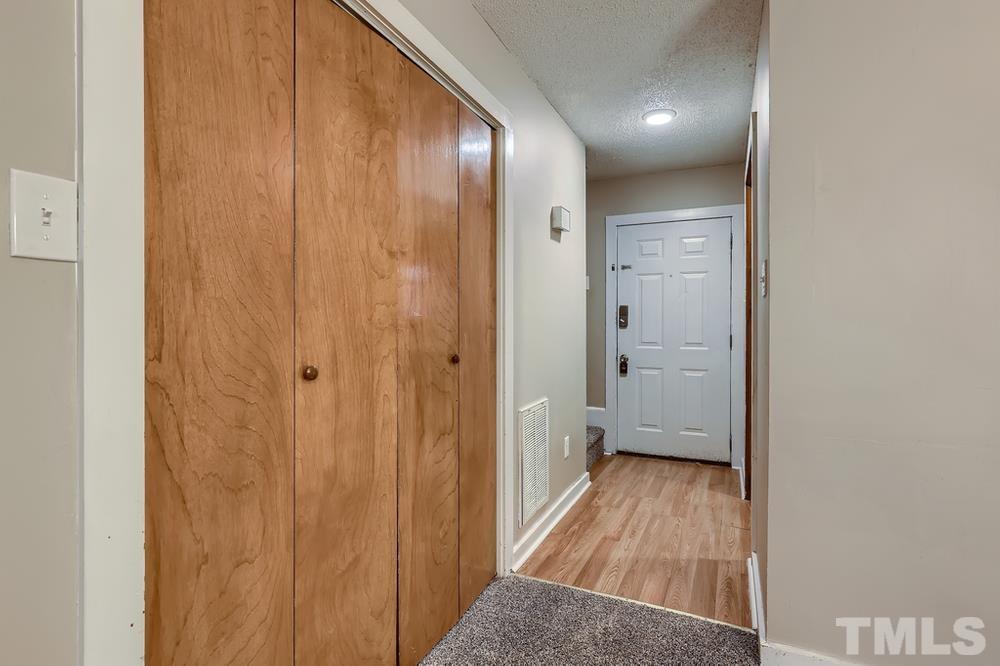 5604 Thea Lane, Unit B Raleigh, NC 27606 - Photo 5 of 27 a view of a hallway with wooden floor