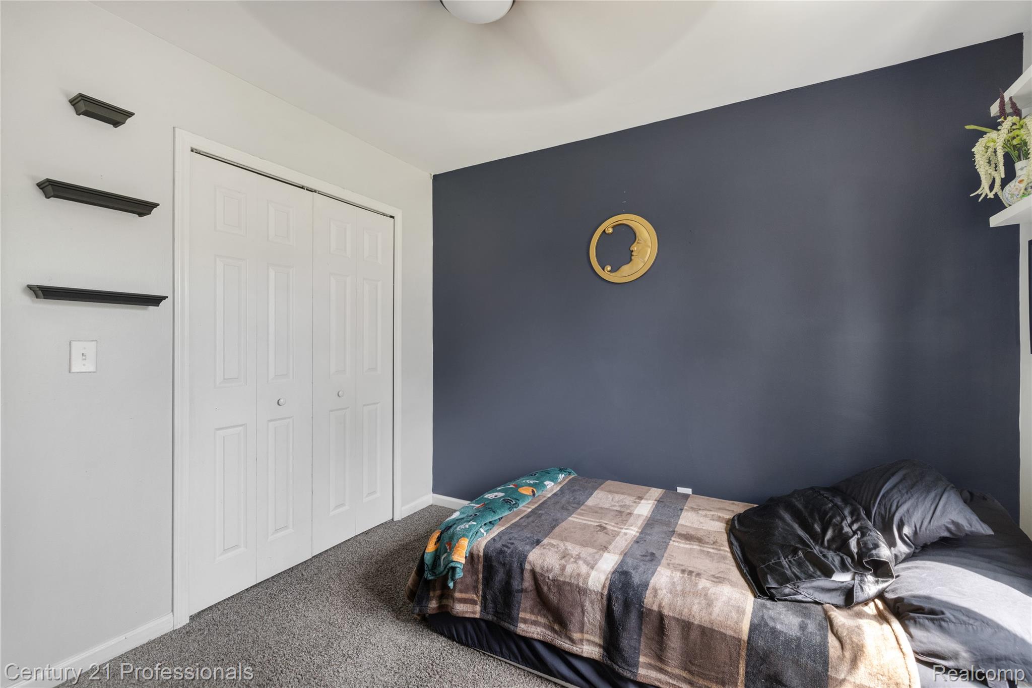 15037 Hogan Road Linden, MI 48451 - Photo 26 of 38 Room featuring a neutral grey carpet and a striking accent wall