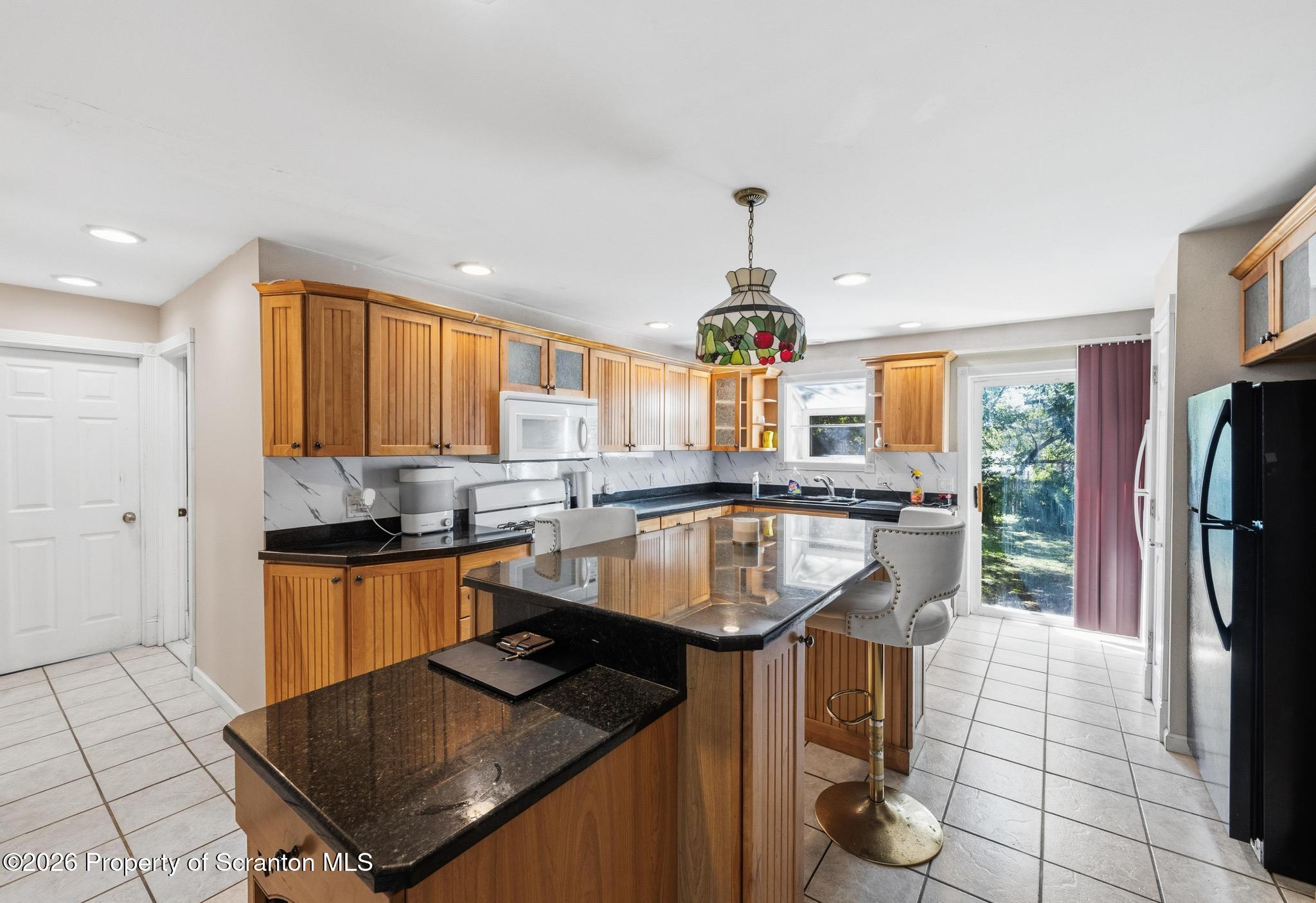 518 Prospect Avenue Scranton, PA 18505 - Photo 14 of 59 a kitchen with stainless steel appliances granite countertop a sink a stove and a refrigerator