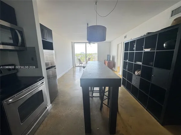 a kitchen with stainless steel appliances a stove a refrigerator and cabinets