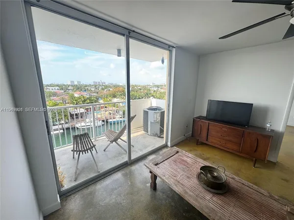 a living room with furniture and a floor to ceiling window