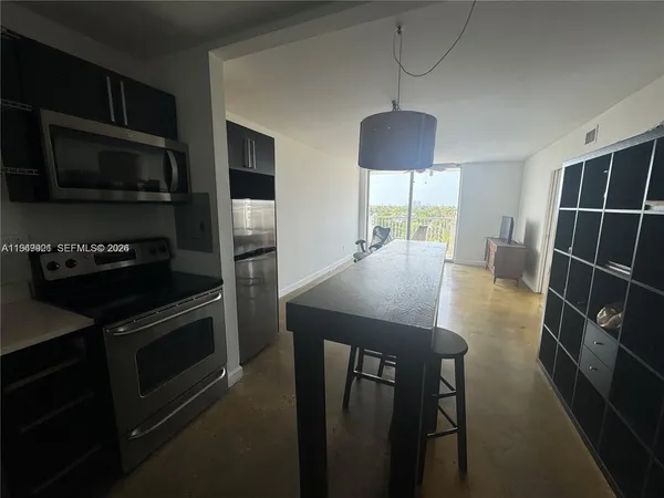a kitchen with refrigerator cabinets and a stove top oven