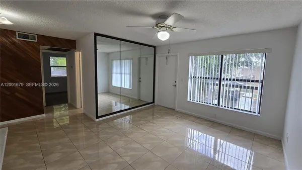 an empty room with windows and closet