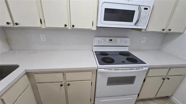 a kitchen with a stove and a microwave