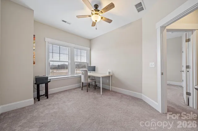 a view of a room with furniture and a window