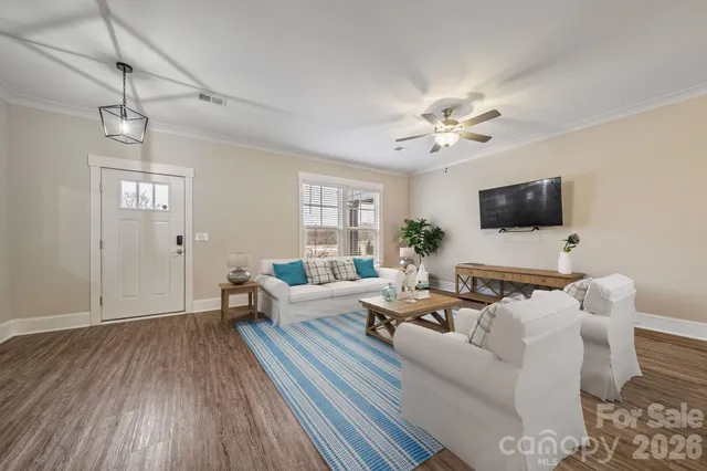 a living room with furniture a ceiling fan and a rug