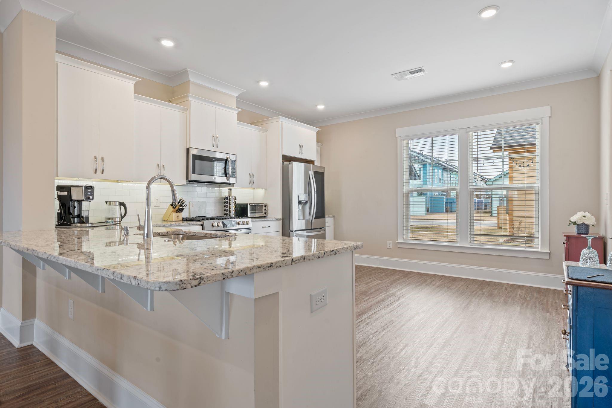 684 Dunkins Ferry Road Rock Hill, SC 29730 - Photo 6 of 32 a kitchen with kitchen island granite countertop a sink window and cabinets