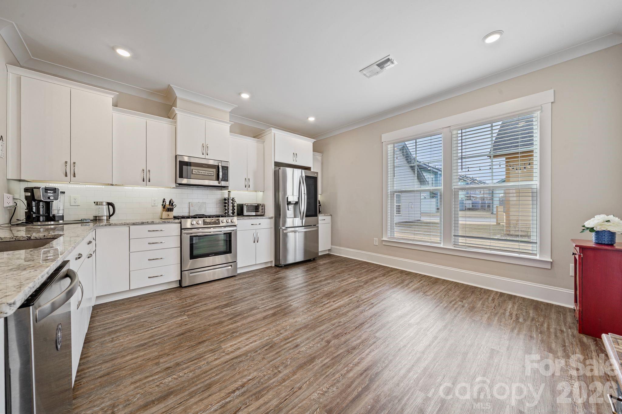 684 Dunkins Ferry Road Rock Hill, SC 29730 - Photo 7 of 32 a kitchen with stove cabinets and wooden floor