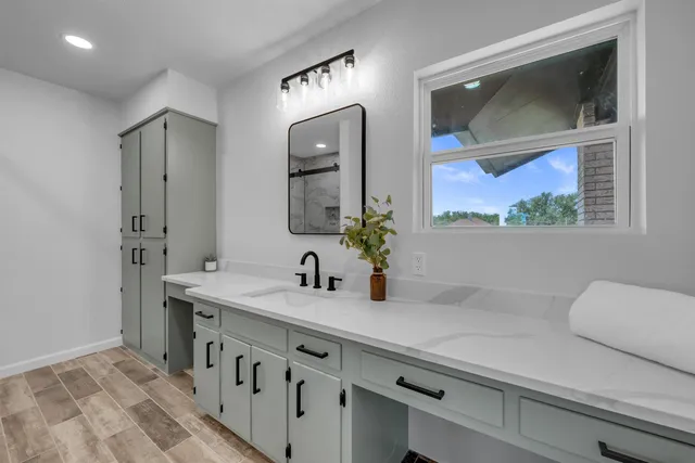 a bathroom with a sink and a mirror