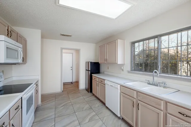 a kitchen with a sink and cabinets