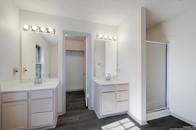 a bathroom with a sink vanity and a mirror