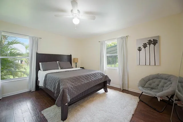 a bedroom with a bed dresser and a window