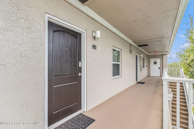 a view of kitchen with hallway and windows