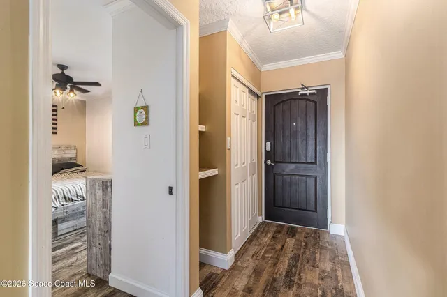 a view of hallway with wooden floor