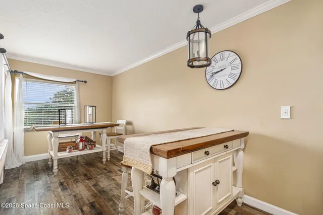 a view of a living room and dining room with wooden floor