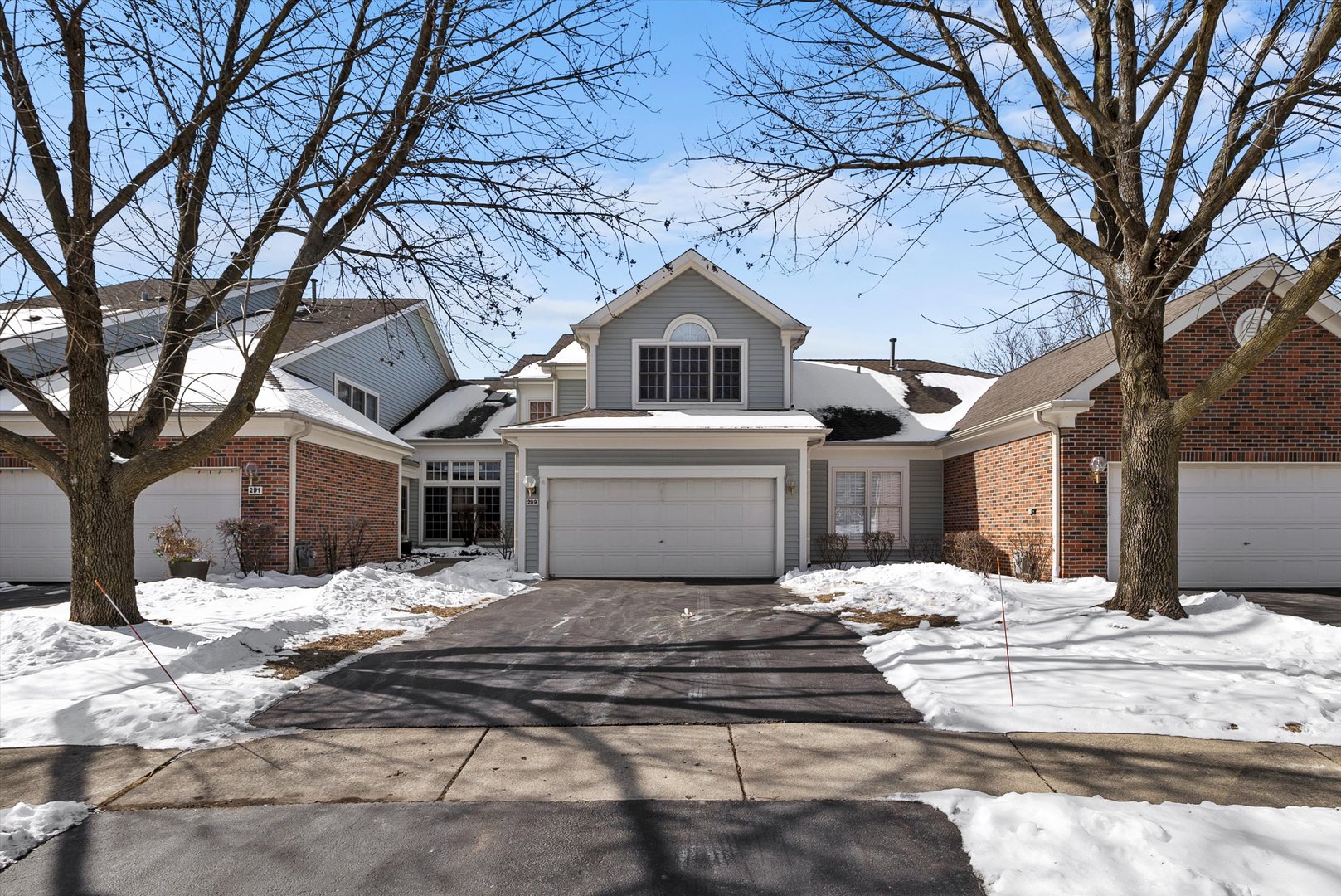 289 Ripplebrook Court Schaumburg, IL 60173 - Photo 1 of 31 a front view of a house with a yard covered in snow