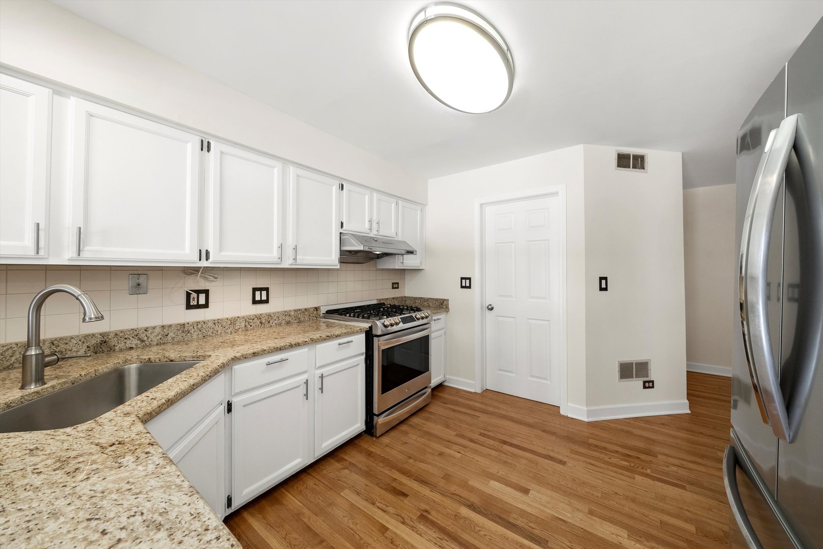 289 Ripplebrook Court Schaumburg, IL 60173 - Photo 11 of 31 a kitchen with white cabinets and stainless steel appliances
