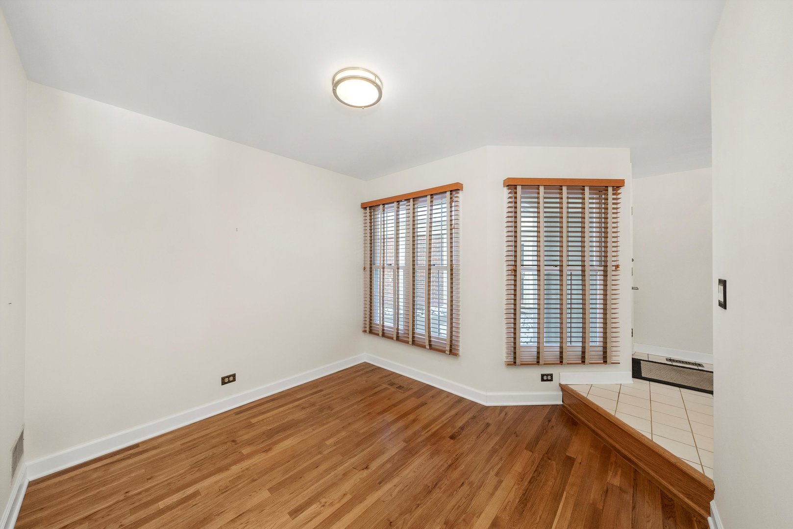 289 Ripplebrook Court Schaumburg, IL 60173 - Photo 13 of 31 a view of a bedroom with wooden floor and a window
