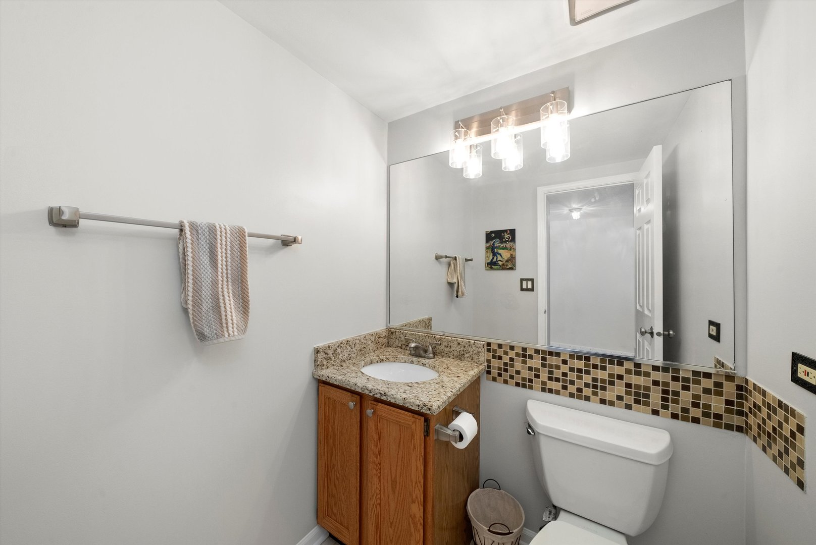 289 Ripplebrook Court Schaumburg, IL 60173 - Photo 14 of 31 a bathroom with a granite countertop sink a toilet a mirror and shower
