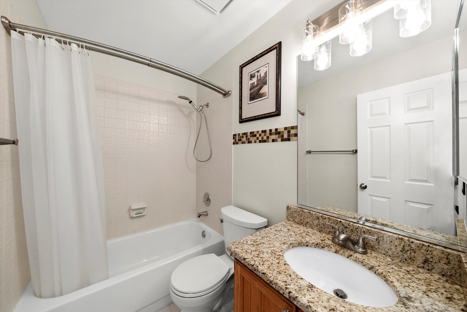 289 Ripplebrook Court Schaumburg, IL 60173 - Photo 18 of 31 a bathroom with a granite countertop sink a mirror a shower and a bathtub