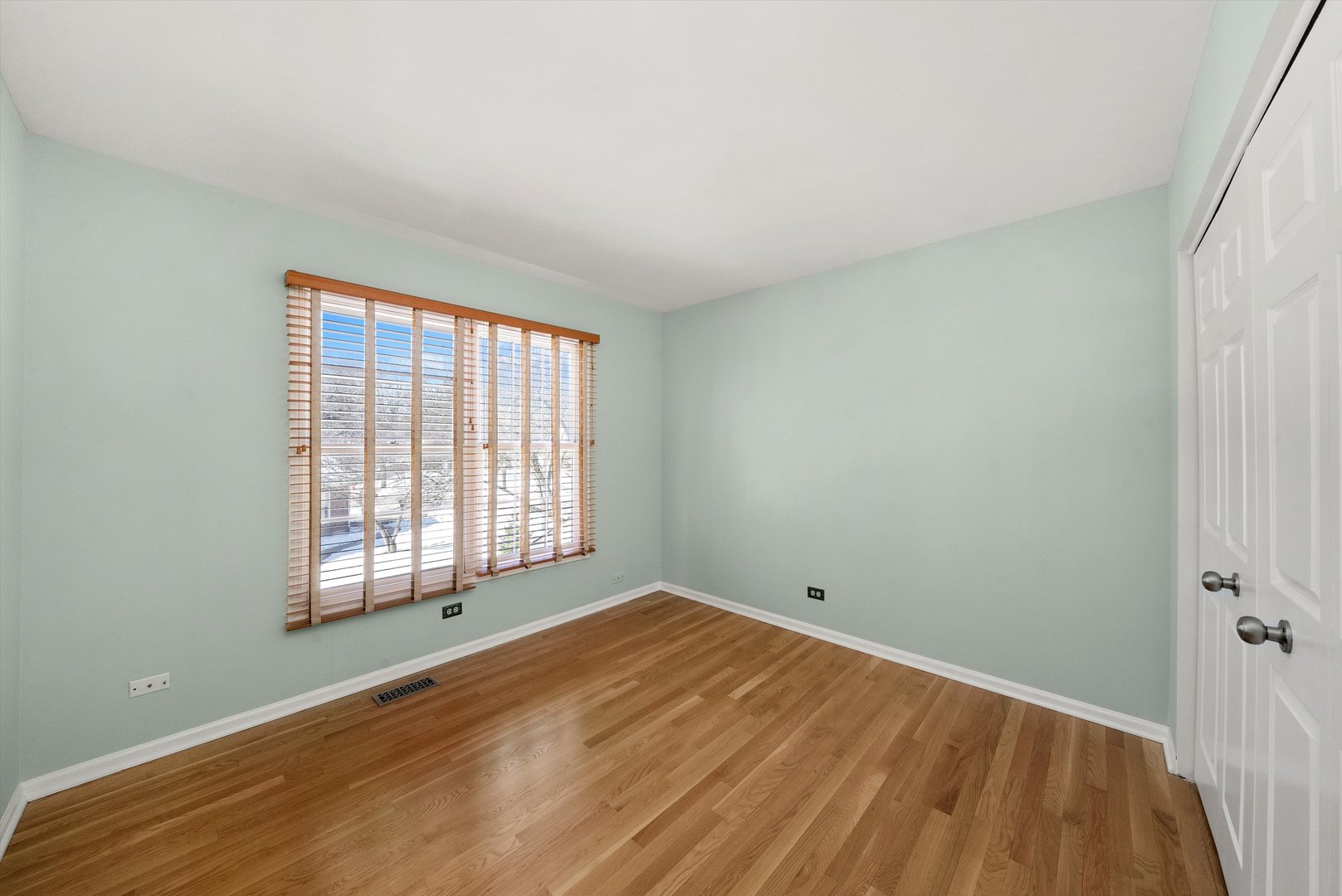 289 Ripplebrook Court Schaumburg, IL 60173 - Photo 19 of 31 an empty room with wooden floor and windows