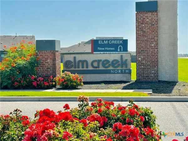 a view of sign board with golf course