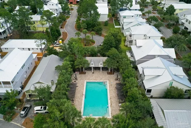 an aerial view of multiple houses with yard