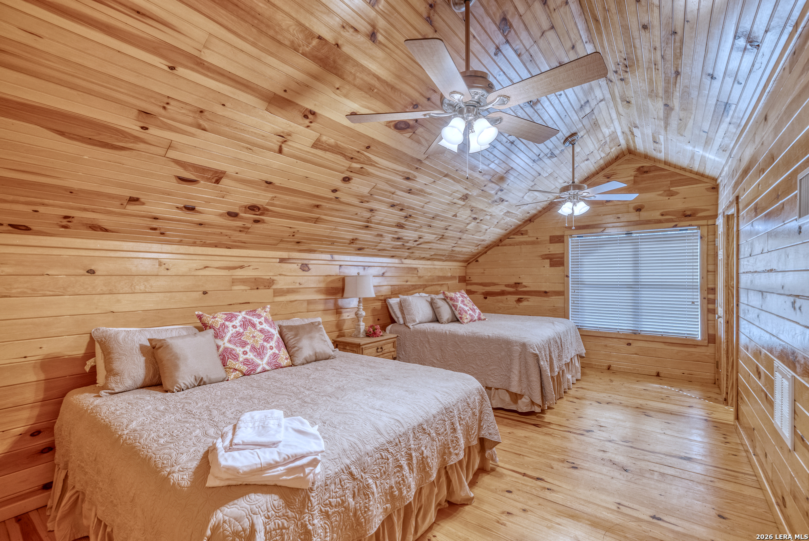 206 South River Pl Road Rio Frio, TX 78879 - Photo 11 of 14 a spacious bedroom with two beds and a chandelier