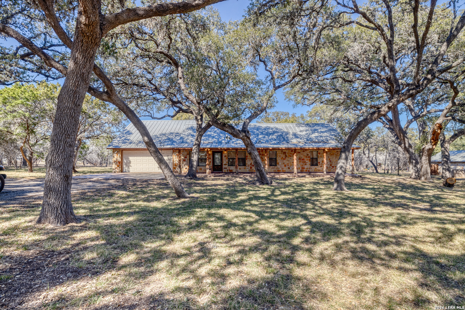 206 South River Pl Road Rio Frio, TX 78879 - Photo 2 of 14 a view of a large house with large trees and a big yard