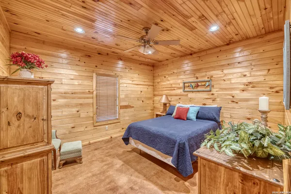 a bedroom with a bed and a potted plant