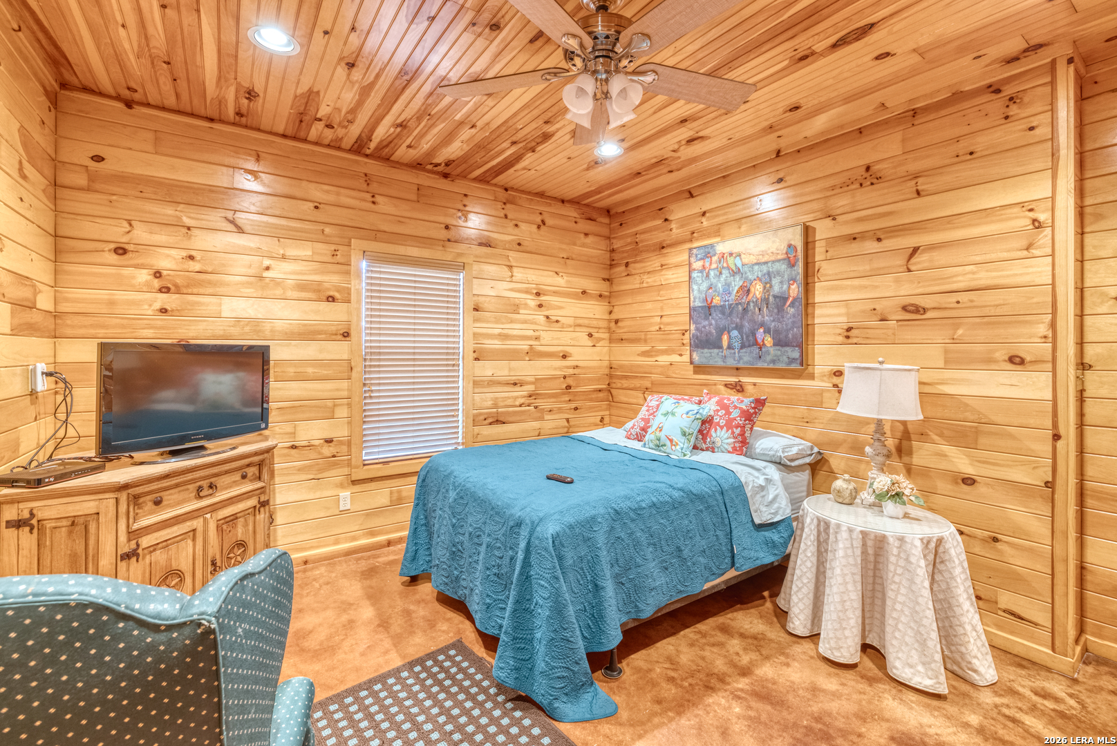 206 South River Pl Road Rio Frio, TX 78879 - Photo 10 of 14 a living room with a bed and flat screen tv