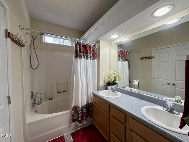 a bathroom with a tub sink and mirror