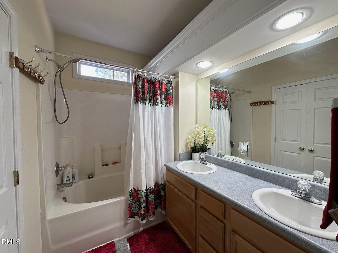 2125 Star Sapphire Drive Raleigh, NC 27610 - Photo 15 of 25 a bathroom with a tub sink and mirror