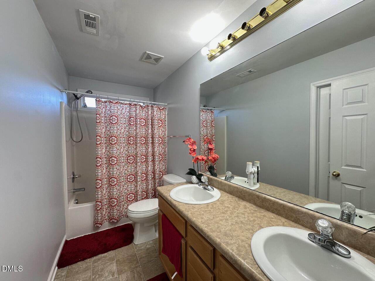 2125 Star Sapphire Drive Raleigh, NC 27610 - Photo 18 of 25 a bathroom with a granite countertop double vanity sink toilet and shower