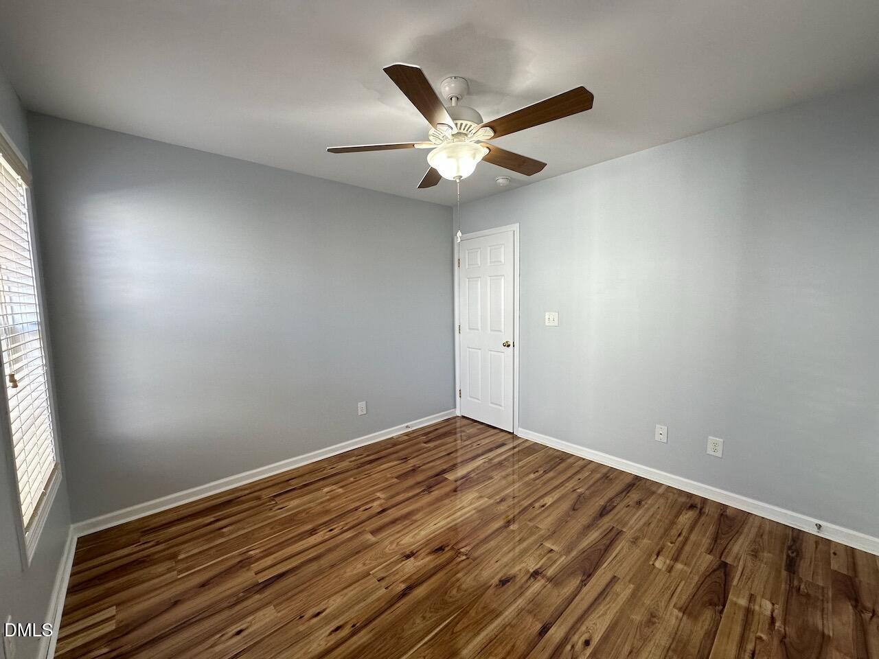 2125 Star Sapphire Drive Raleigh, NC 27610 - Photo 20 of 25 an empty room with wooden floor fan and windows